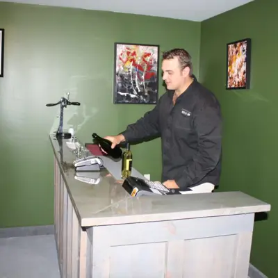 Man behind the counter at Bains Road Cider's on-farm store