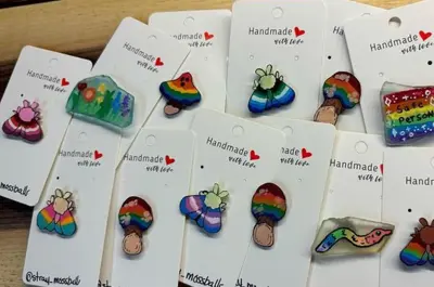 Brightly couloured mushroom and other shaped pins on cards