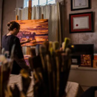 Woman Painting A Sunset Landscape