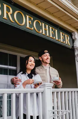couple drinking coffee on BnB porch looking out into scenery