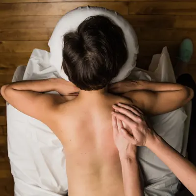 A woman lies on a massage table