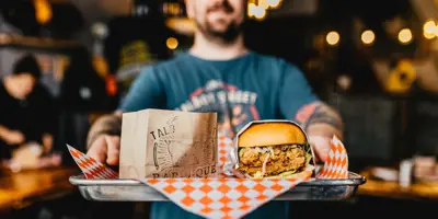 Talbot Street Grill Server Holding Tray With Burger And Fries