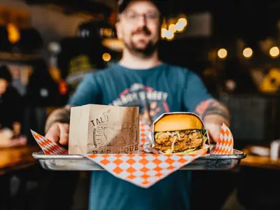 Talbot Street Grill Server Holding Tray With Burger And Fries