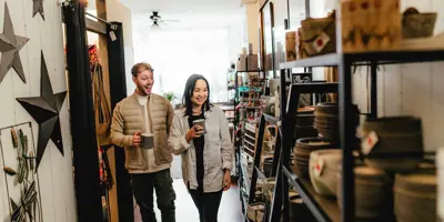 Couple Browsing Aisle In Local Shop