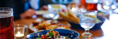 A dining table set with colourful dishes