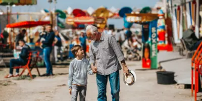 Grandfather and grandson at a summer festival