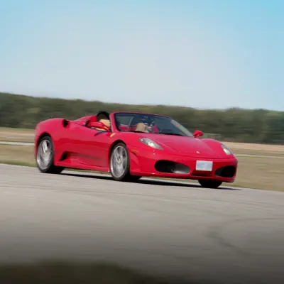 A fast red high performance car on a road