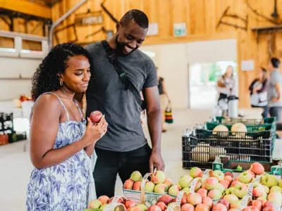 A couple select apples at the market