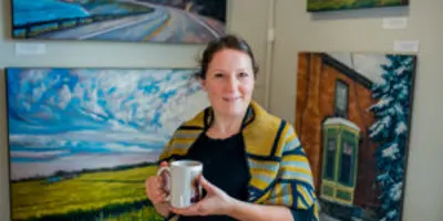 Woman Holding Mug With Paintings