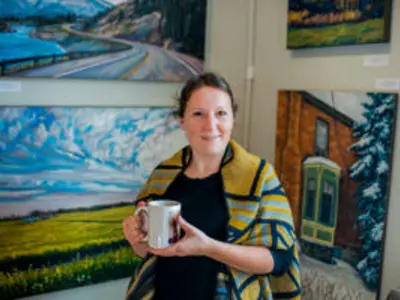 Woman Holding Mug With Paintings