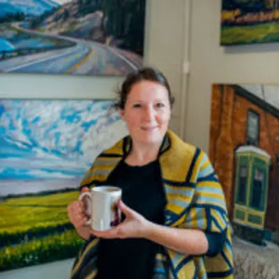 Woman Holding Mug With Paintings